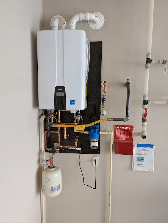 Professional plumber installing copper piping in a Zumbrota home